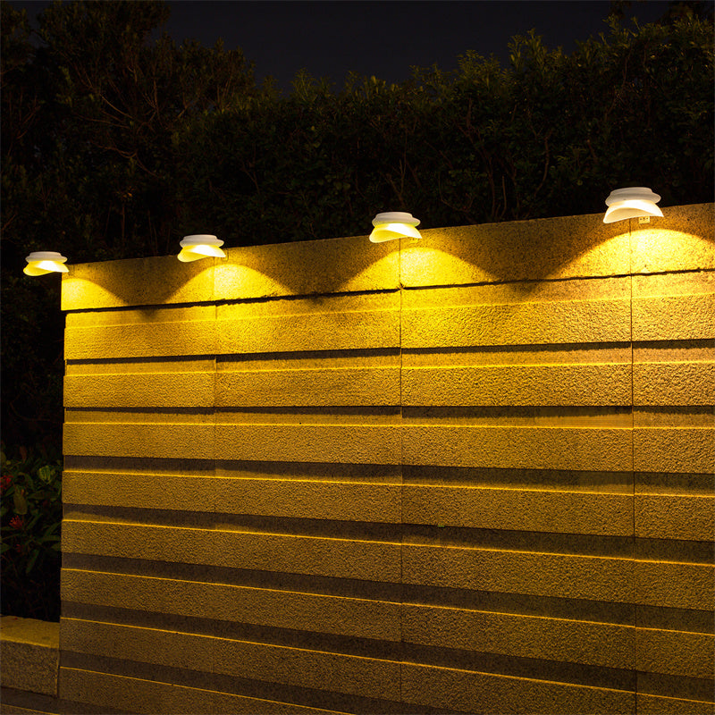 Solar-powered LED outdoor wall light mounted on fence